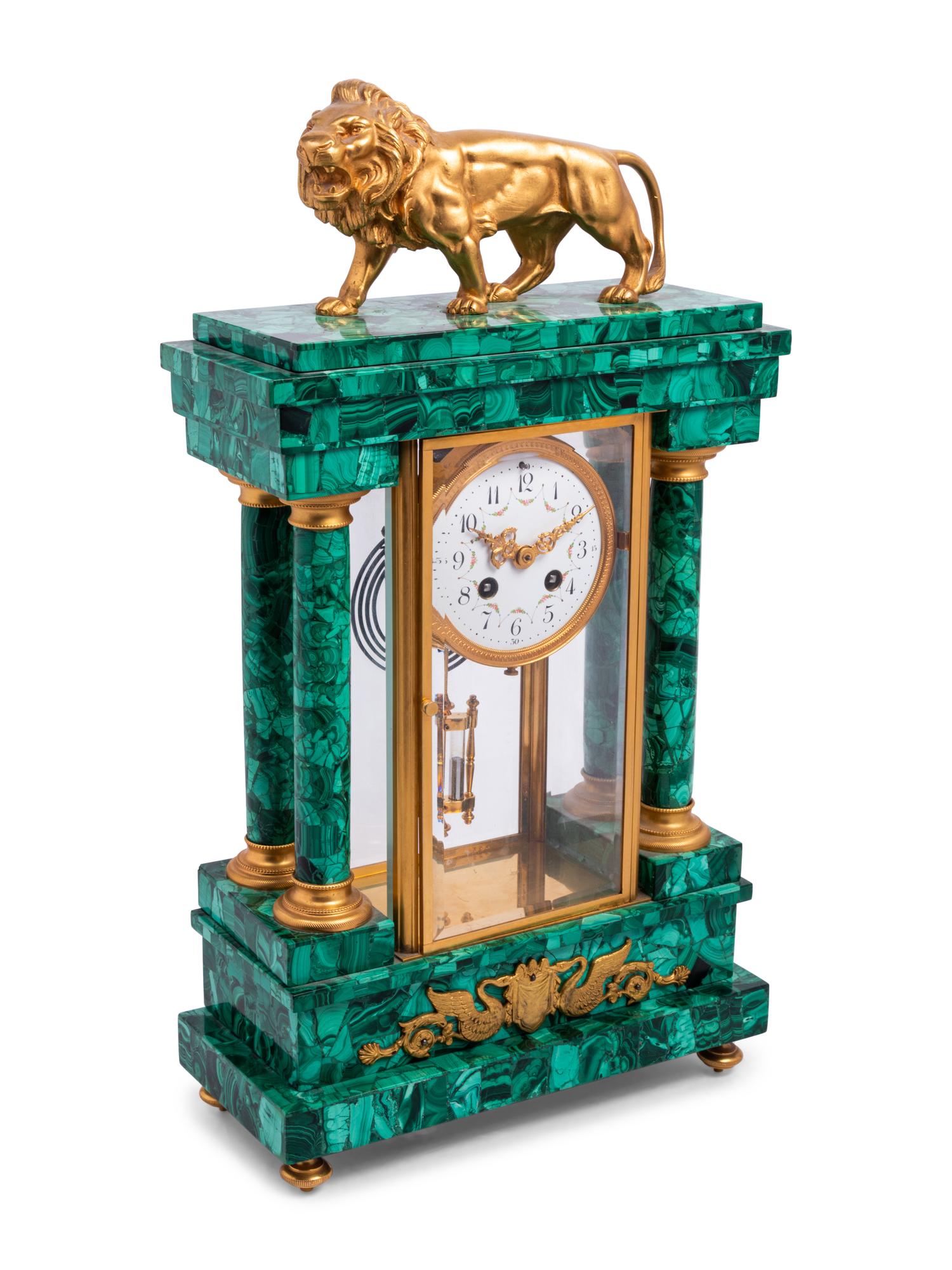An Empire Style Gilt Metal and Malachite Veneered “Crystal Regulator" Clock