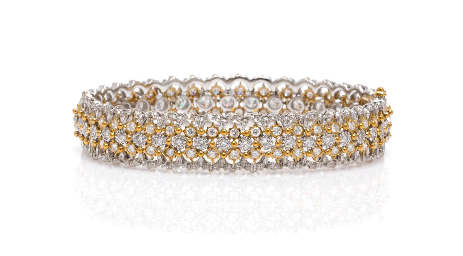 An 18 Karat Two Tone Gold and Diamond Bangle Bracelet, 17.30 dwts.