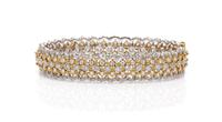 An 18 Karat Two Tone Gold and Diamond Bangle Bracelet, 17.30 dwts.