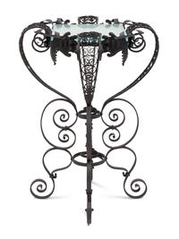 A Spanish Colonial Style Wrought Iron and Glass Stand