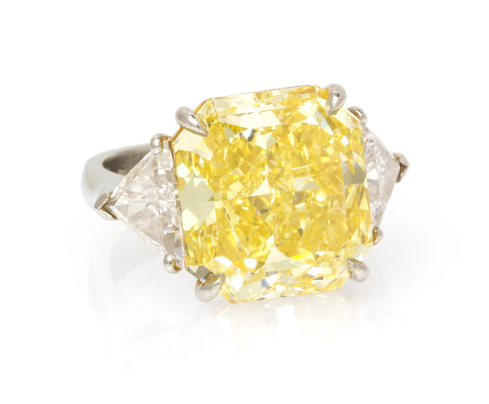 A Fine Platinum, Fancy Intense Yellow Diamond and Diamond Ring, 7.40 dwts.