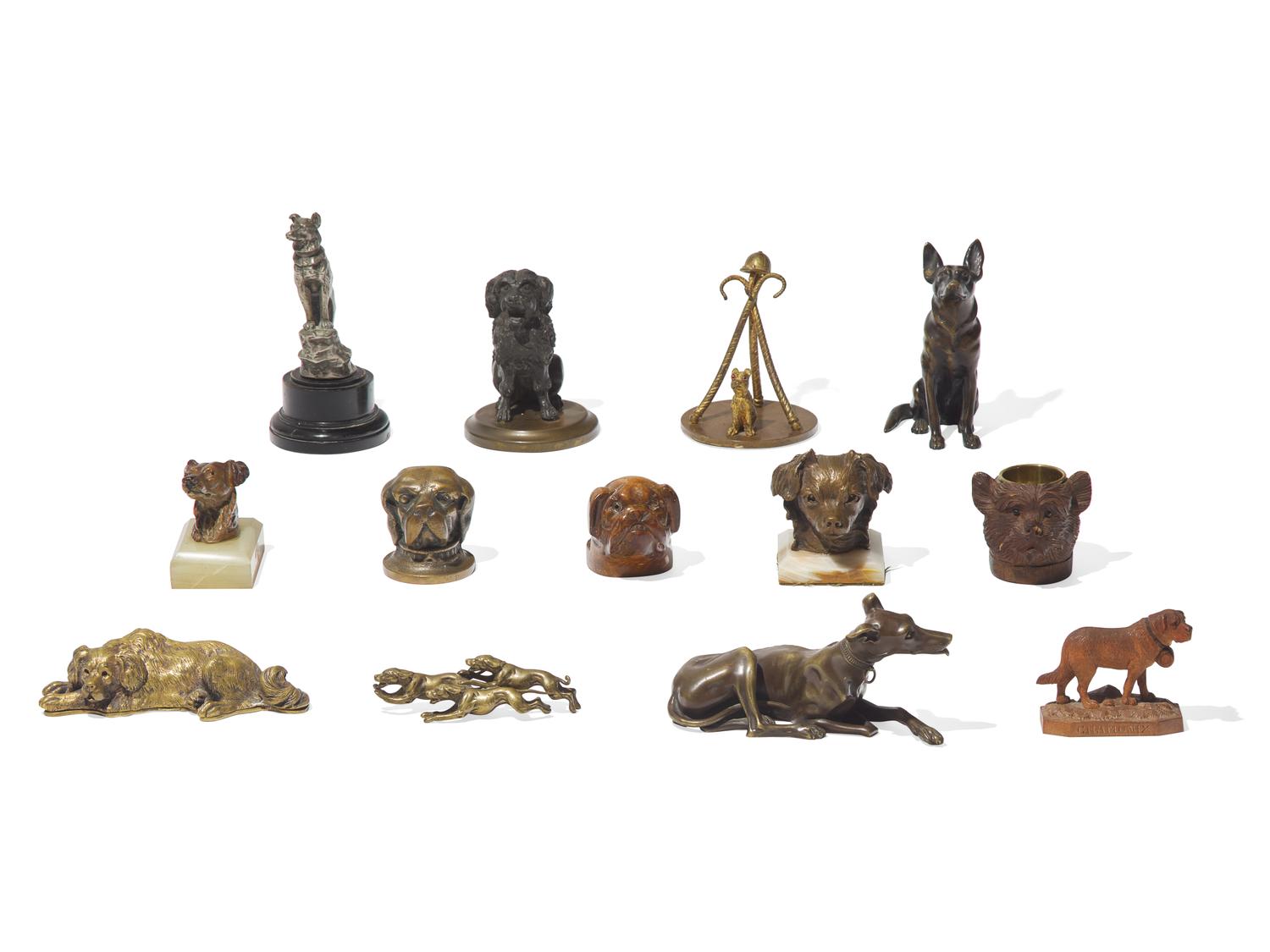A Collection of Thirteen Cast Metal and Carved Wood Dog Figures and Articles