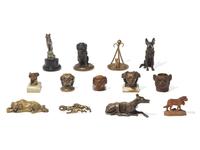 A Collection of Thirteen Cast Metal and Carved Wood Dog Figures and Articles