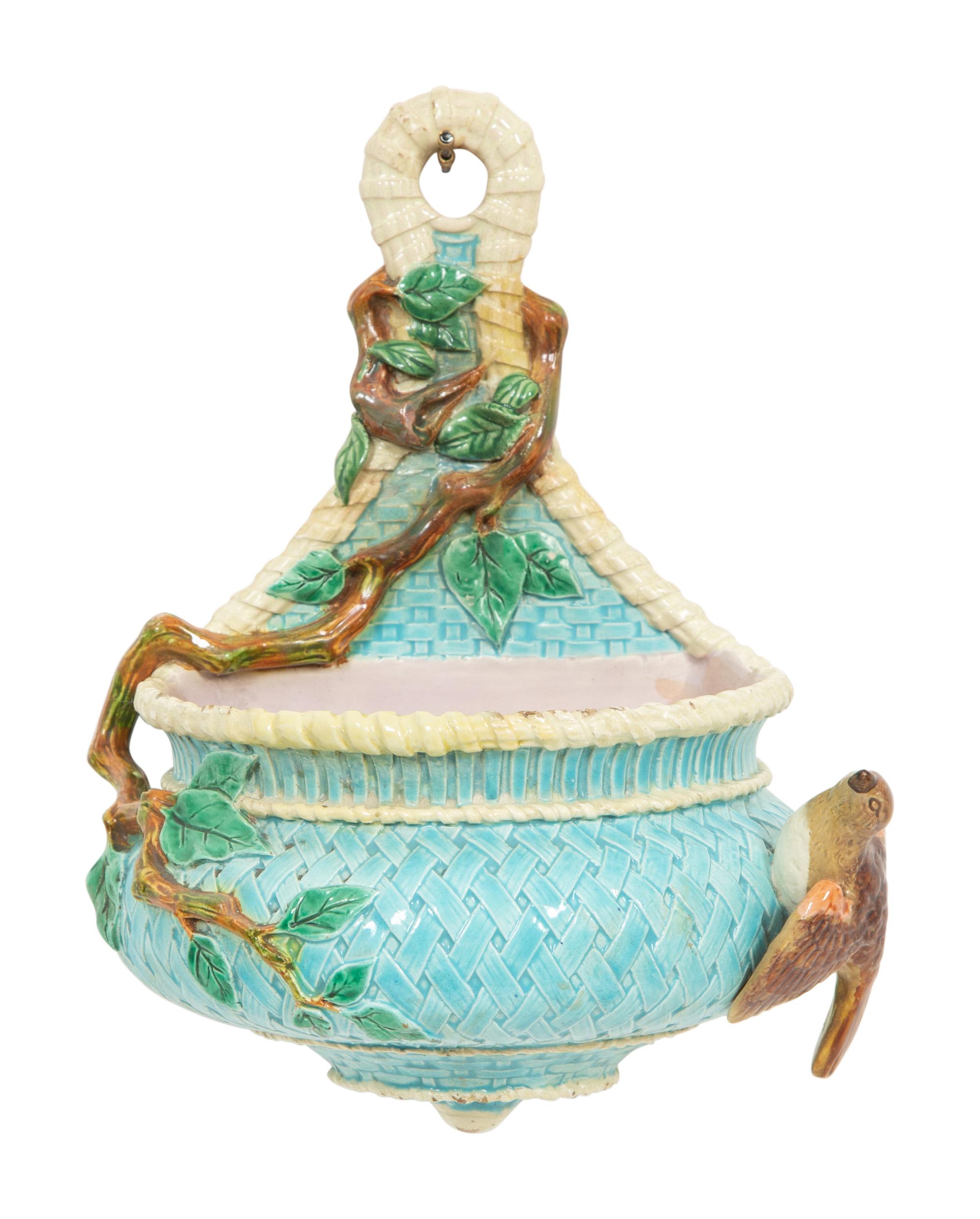 An English Majolica Jardiniere with Stand and a Cistern-form Wall Pocket