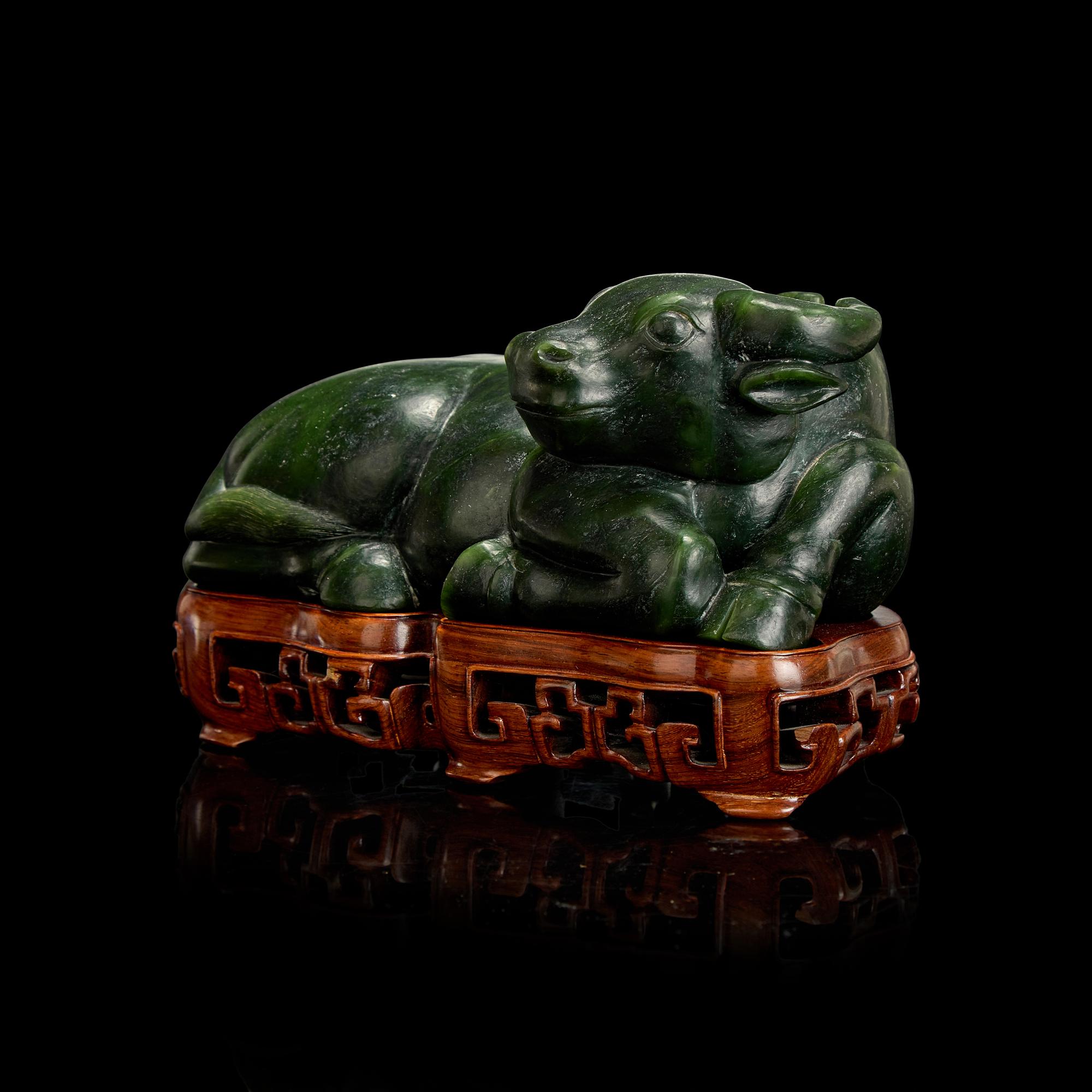 A Chinese Spinach Jade Buffalo, Qing Dynasty 清 青玉臥牛