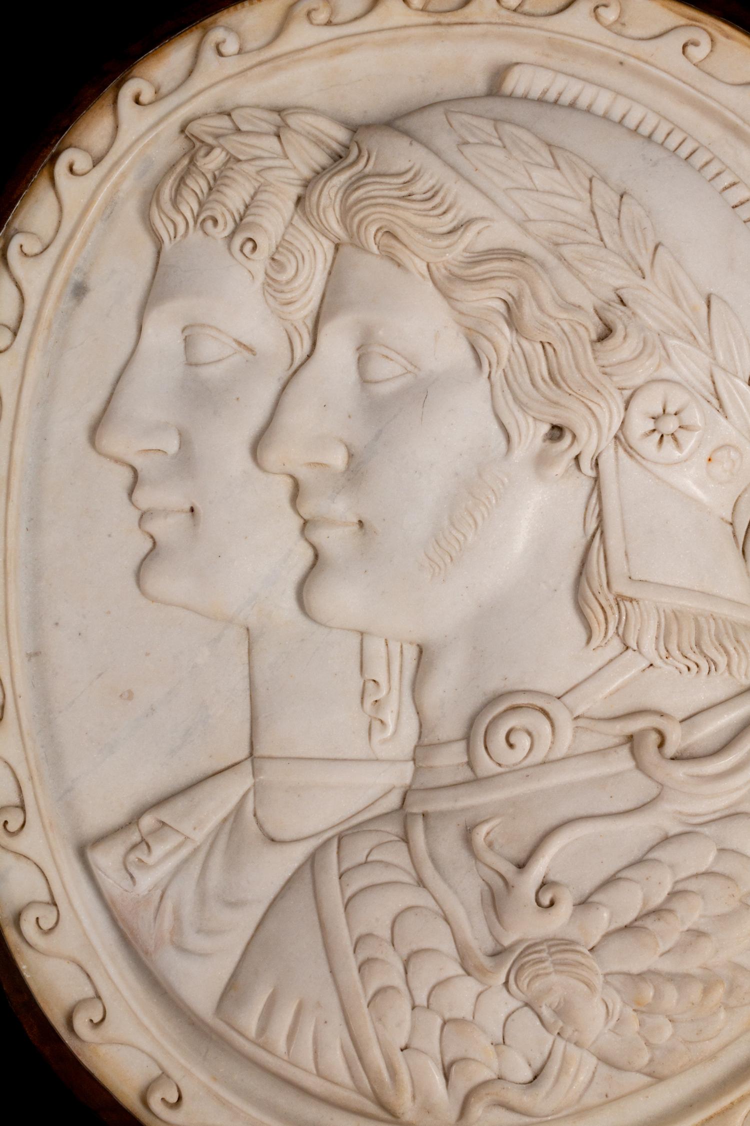 A Pair of Italian Neoclassical Style Iron-Mounted Marble Portrait Reliefs of a Caesar