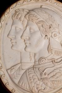A Pair of Italian Neoclassical Style Iron-Mounted Marble Portrait Reliefs of a Caesar