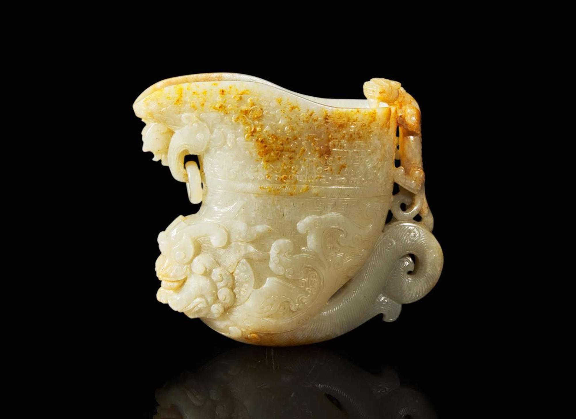 A large Chinese carved pale celadon and russet jade rhyton vessel 青白玉雕觥杯