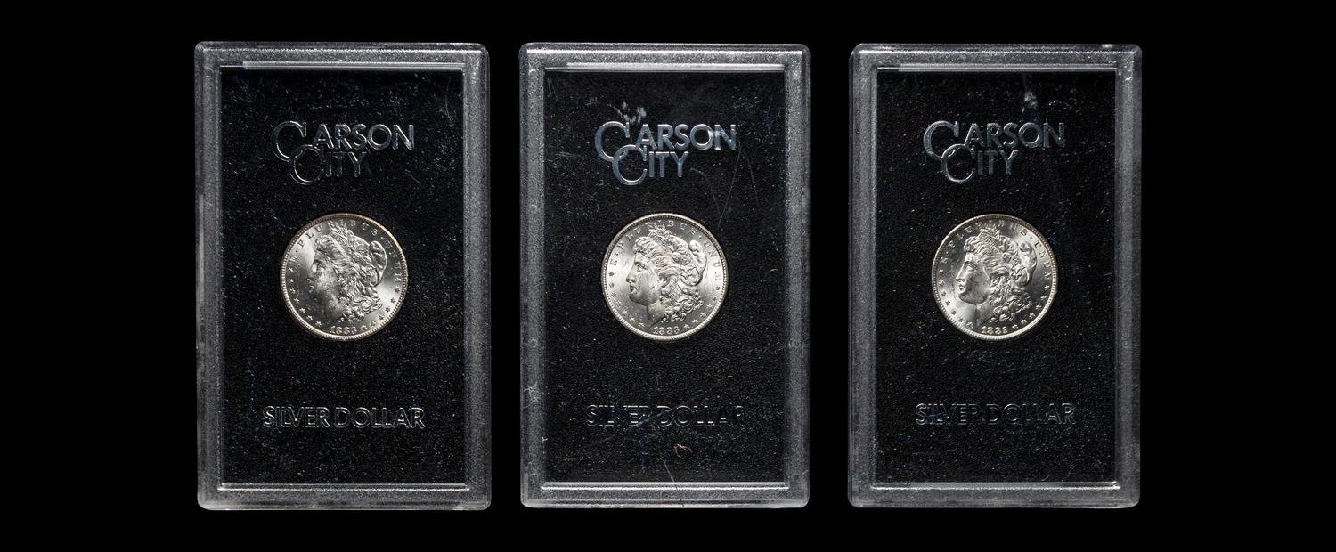 A Group of Three 1883-CC GSA: Morgan $1 Coins