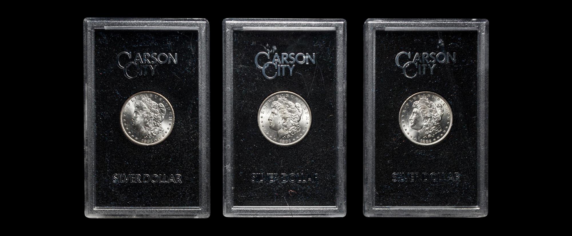 A Group of Three 1883-CC GSA: Morgan $1 Coins