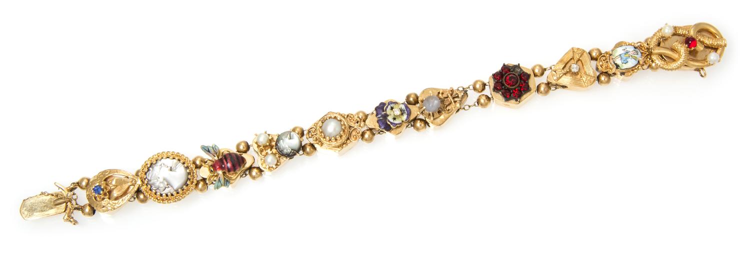 A Vintage 14 Karat Yellow Gold, Enamel and Multi Gem Charm Slide Bracelet, 24.50 dwts.