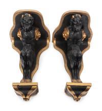 A Pair of Continental Ebonized and Parcel Gilt Wood Figural Brackets