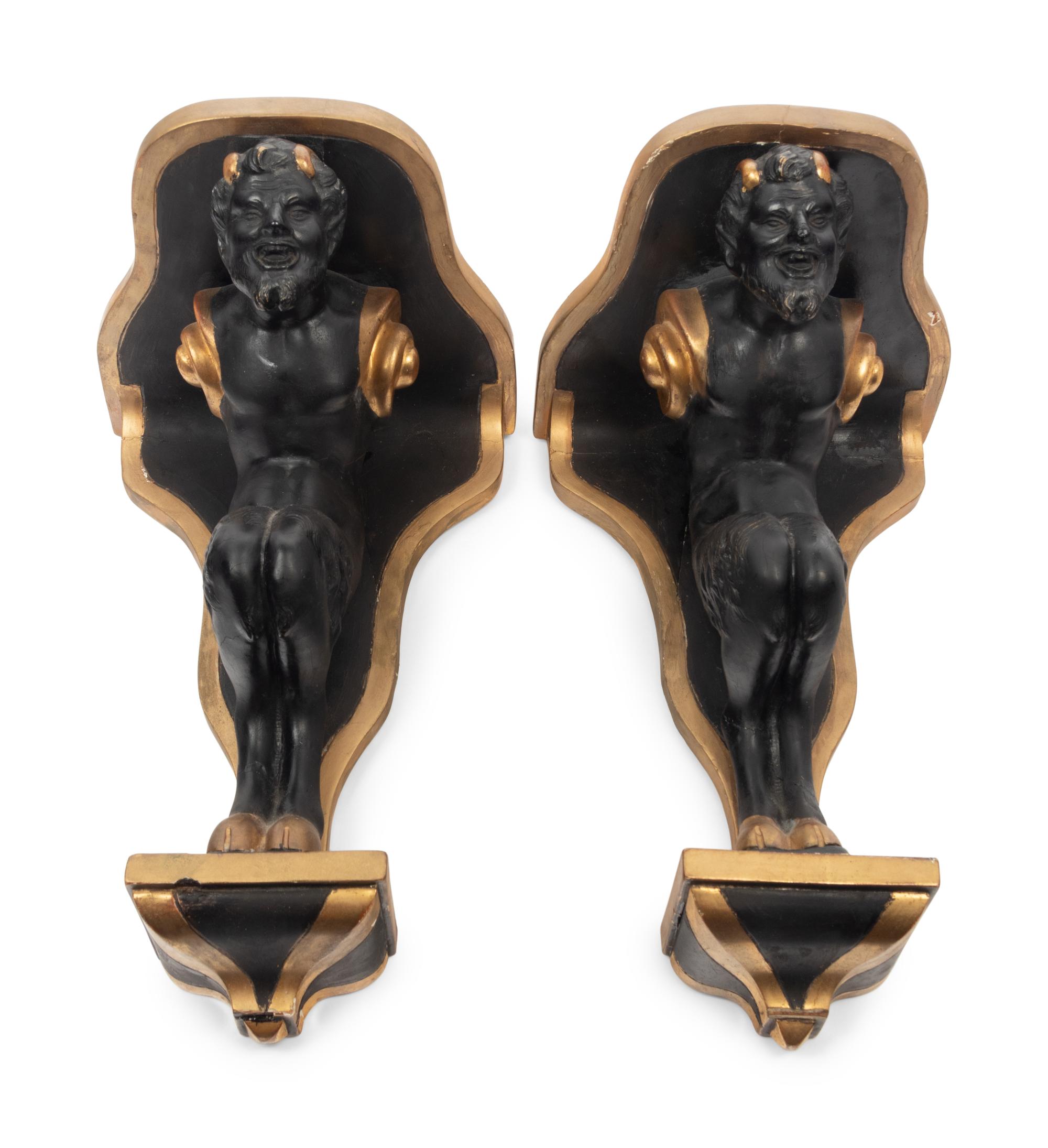 A Pair of Continental Ebonized and Parcel Gilt Wood Figural Brackets