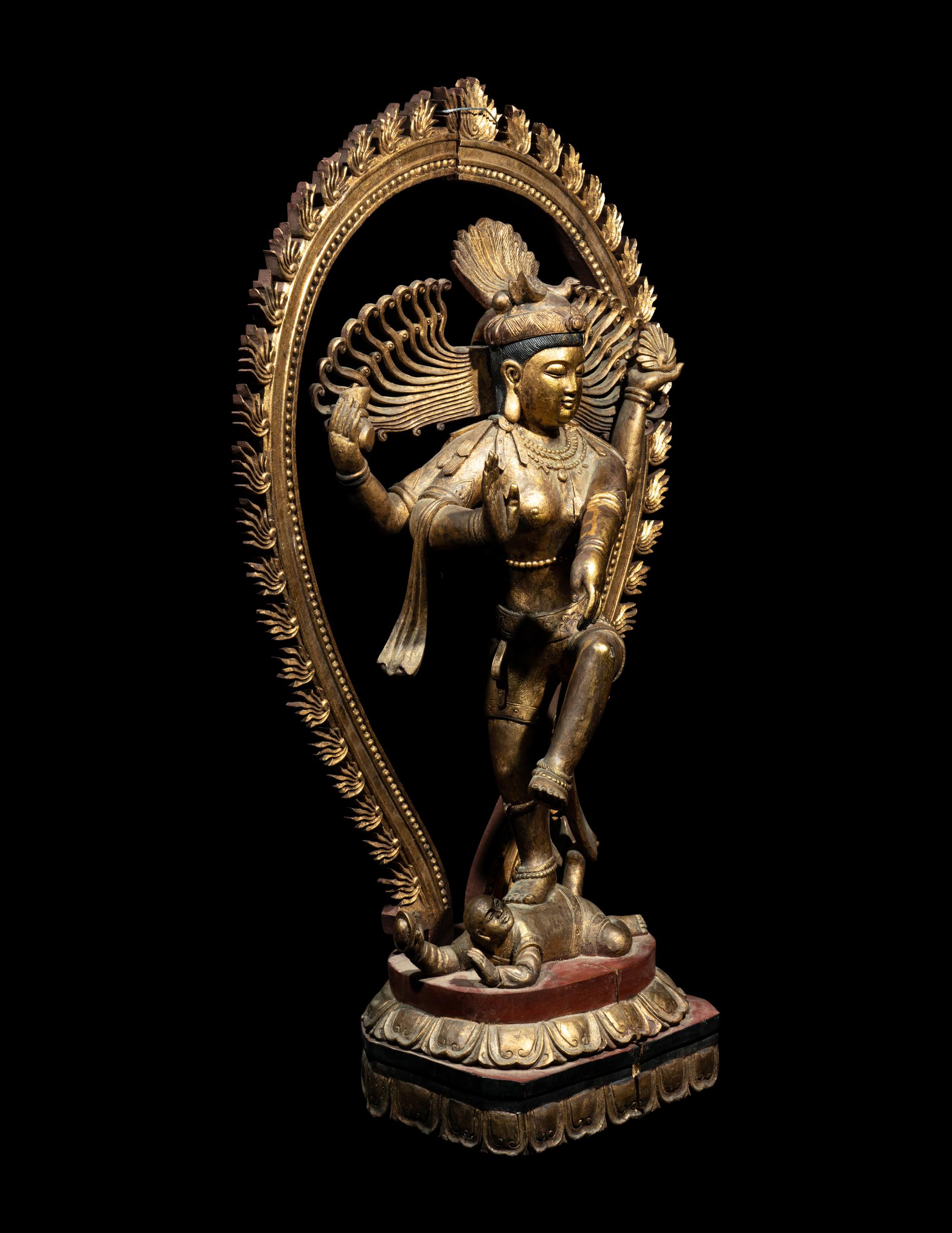 A Large Gilt and Red Lacquered Wood Figure of a Dancing Deity