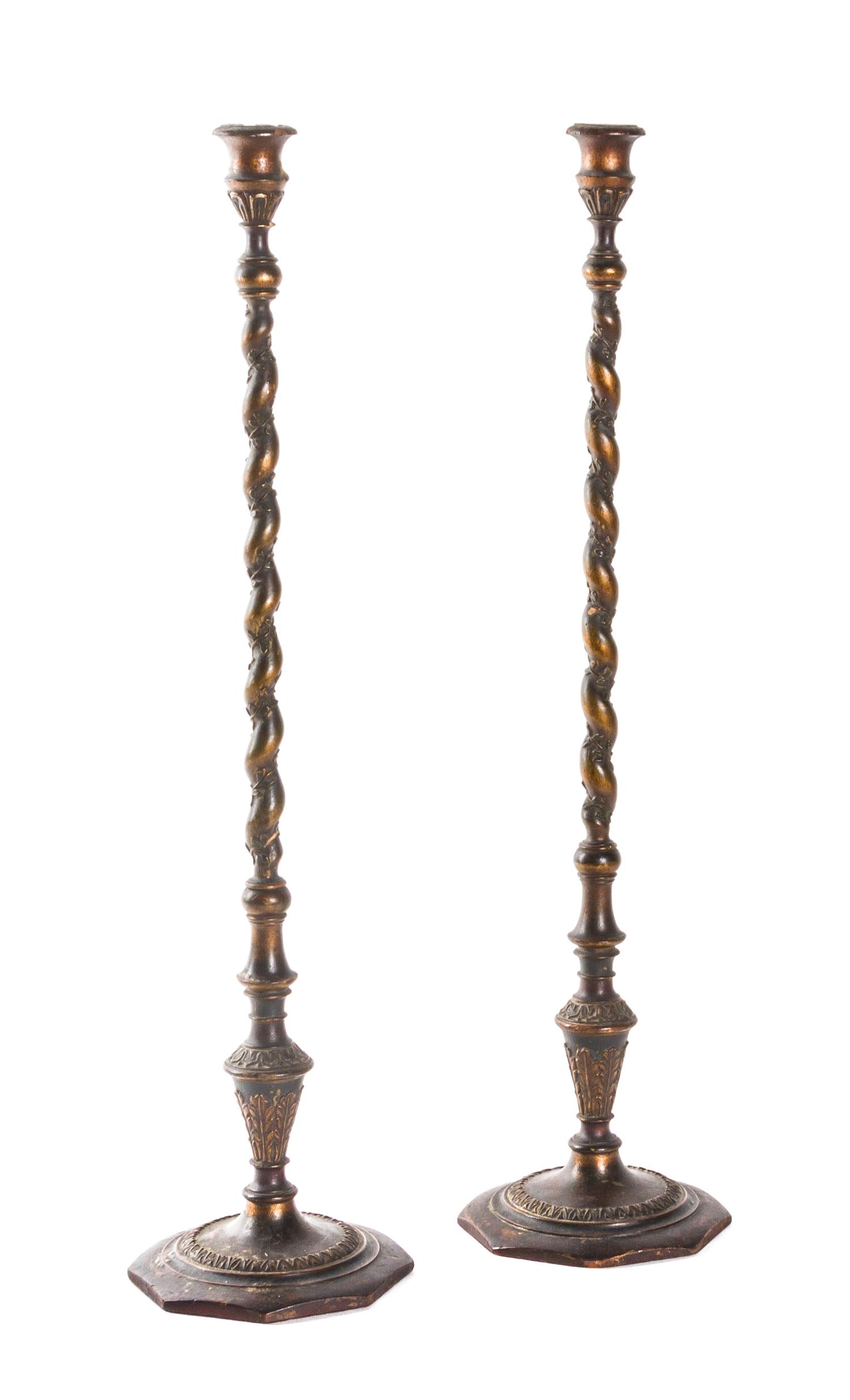 A Pair of Continental Carved and Parcel Giltwood Candlesticks, Height 24 3/4 inches.