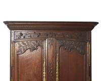 A Louis XVI carved oak armoire, late 18th century