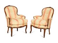 A Pair of Louis XV Style Walnut Bergères