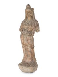 A Chinese Carved Stone Standing Guanyin Figure with Remnants of Polychrome Decoration