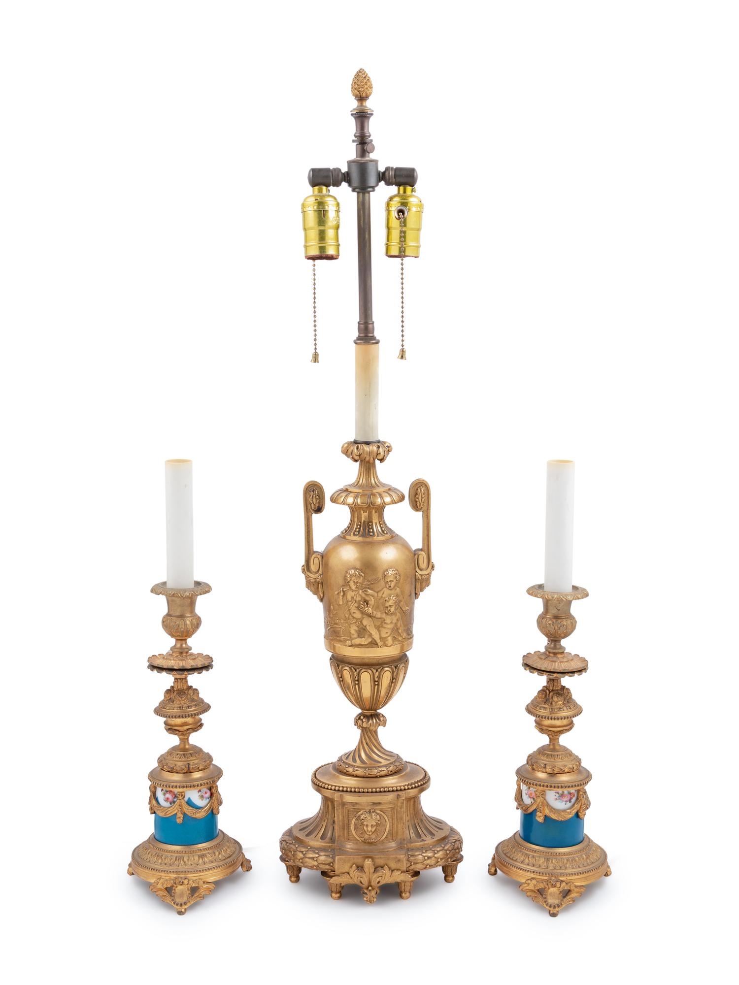 A Neoclassical Gilt Bronze Urn Mounted as a Lamp and a Pair of Porcelain Mounted Gilt Bronze Candlesticks