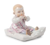 A Meissen Porcelain Figure of a Baby Feeding ,by Konrad Hentschel