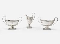 A George III sterling silver creamer together with a pair of Sheffield plate sauce tureens, the creamer by Peter and Ann Bateman, London, 1795, the pair of sauce tureens late 18th / early 19th century