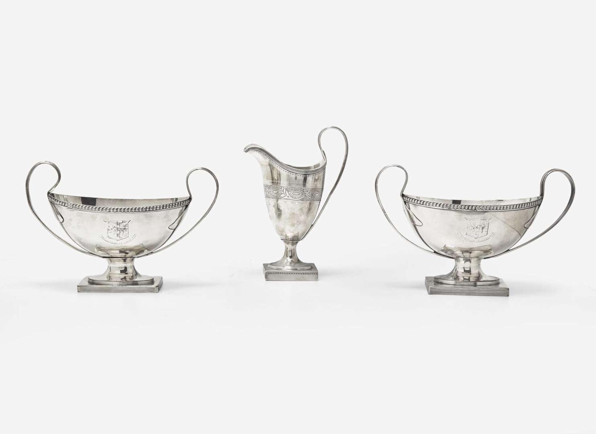 A George III sterling silver creamer together with a pair of Sheffield plate sauce tureens, the creamer by Peter and Ann Bateman, London, 1795, the pair of sauce tureens late 18th / early 19th century