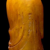 A Chinese Carved Stone "Luohan" Seal and a Yellow "Peking" Glass Bowl 壽山石雕羅漢和黃料花卉紋盌各一