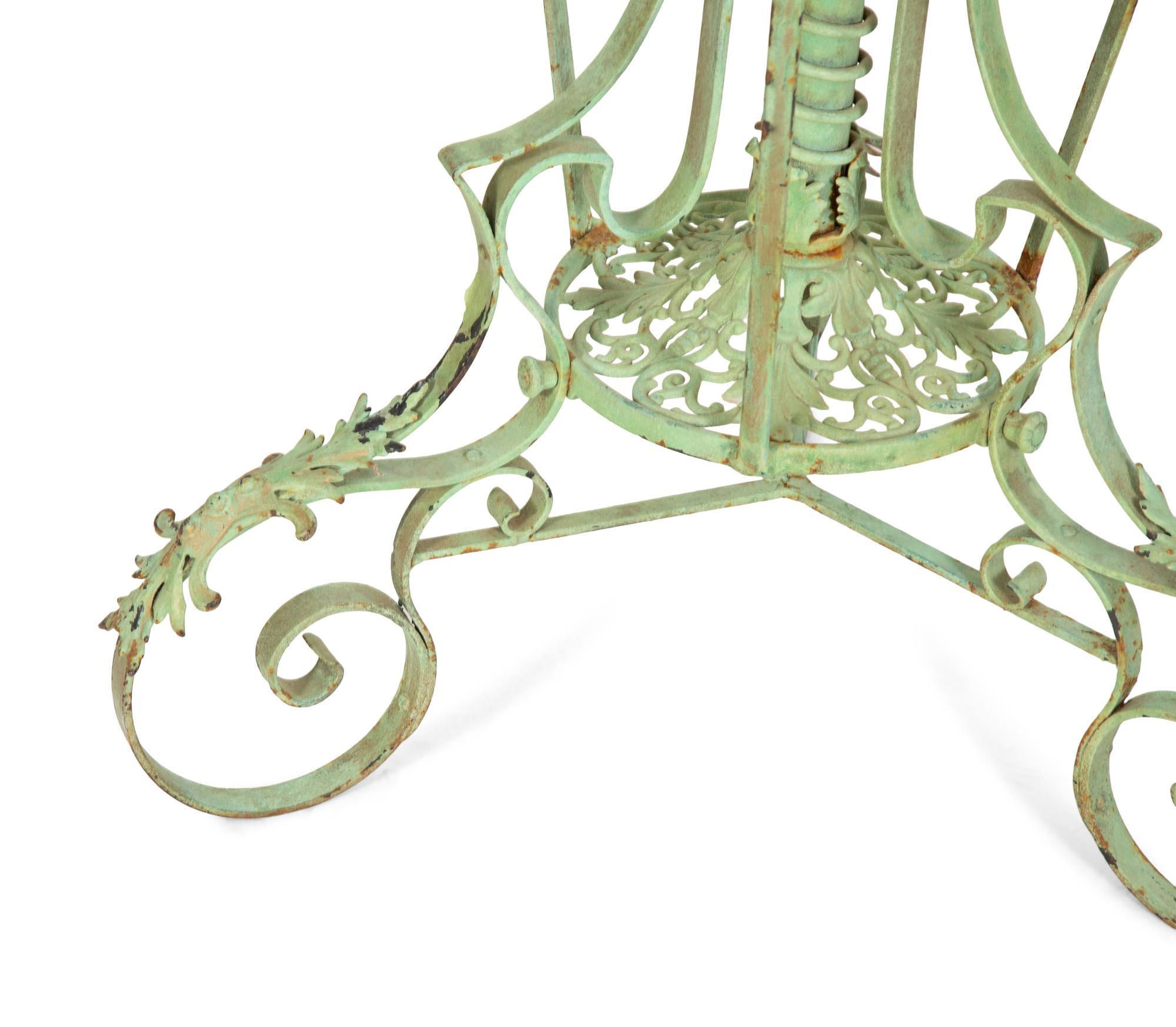 A Fornasetti Citta di Carte Table Top on Painted Wrought Iron Base