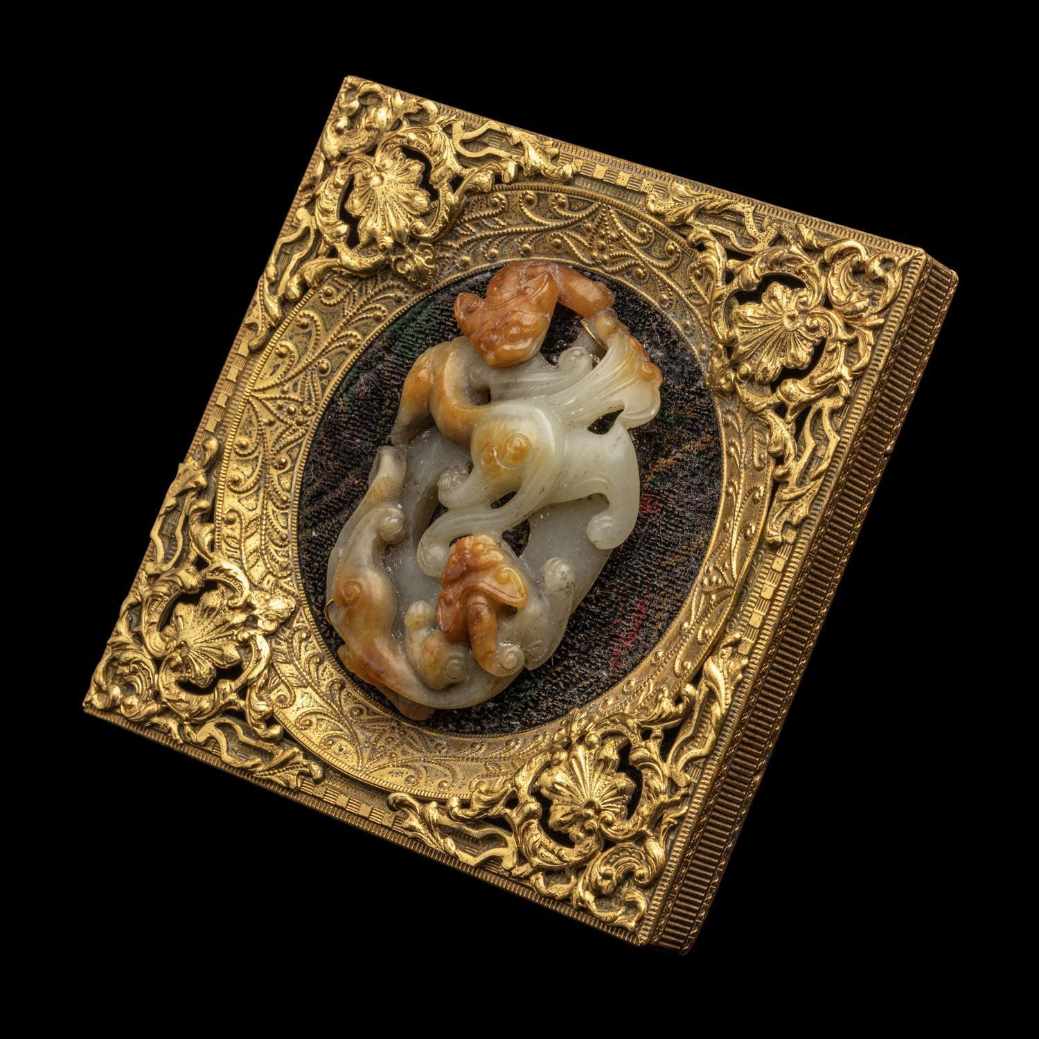 A Chinese Russet and Pale Celadon Jade 'Double Dragons' Pendant