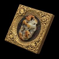 A Chinese Russet and Pale Celadon Jade 'Double Dragons' Pendant