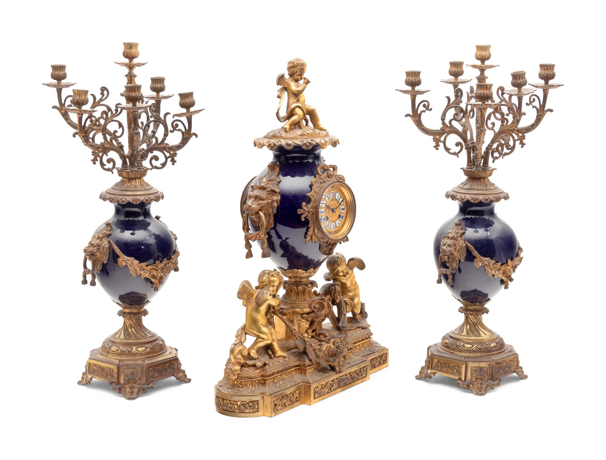 A French Gilt Bronze and Porcelain Clock Garniture