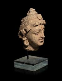 A Small Gandharan Polychromed Stucco Head of a Bodhisattva