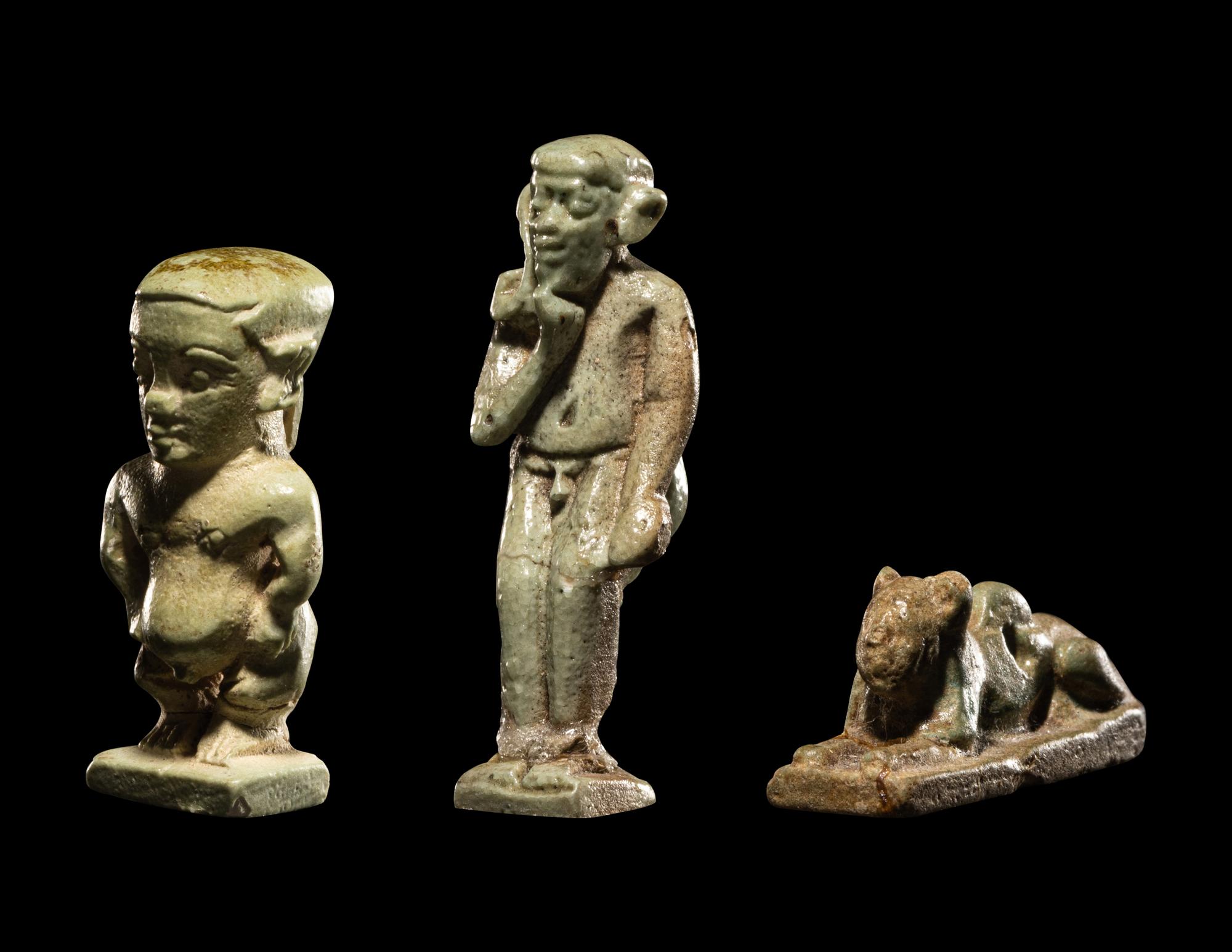 Three Egyptian Faience Amulets Including a Pataikos, a Harpocrates, and a Recumbent Lion