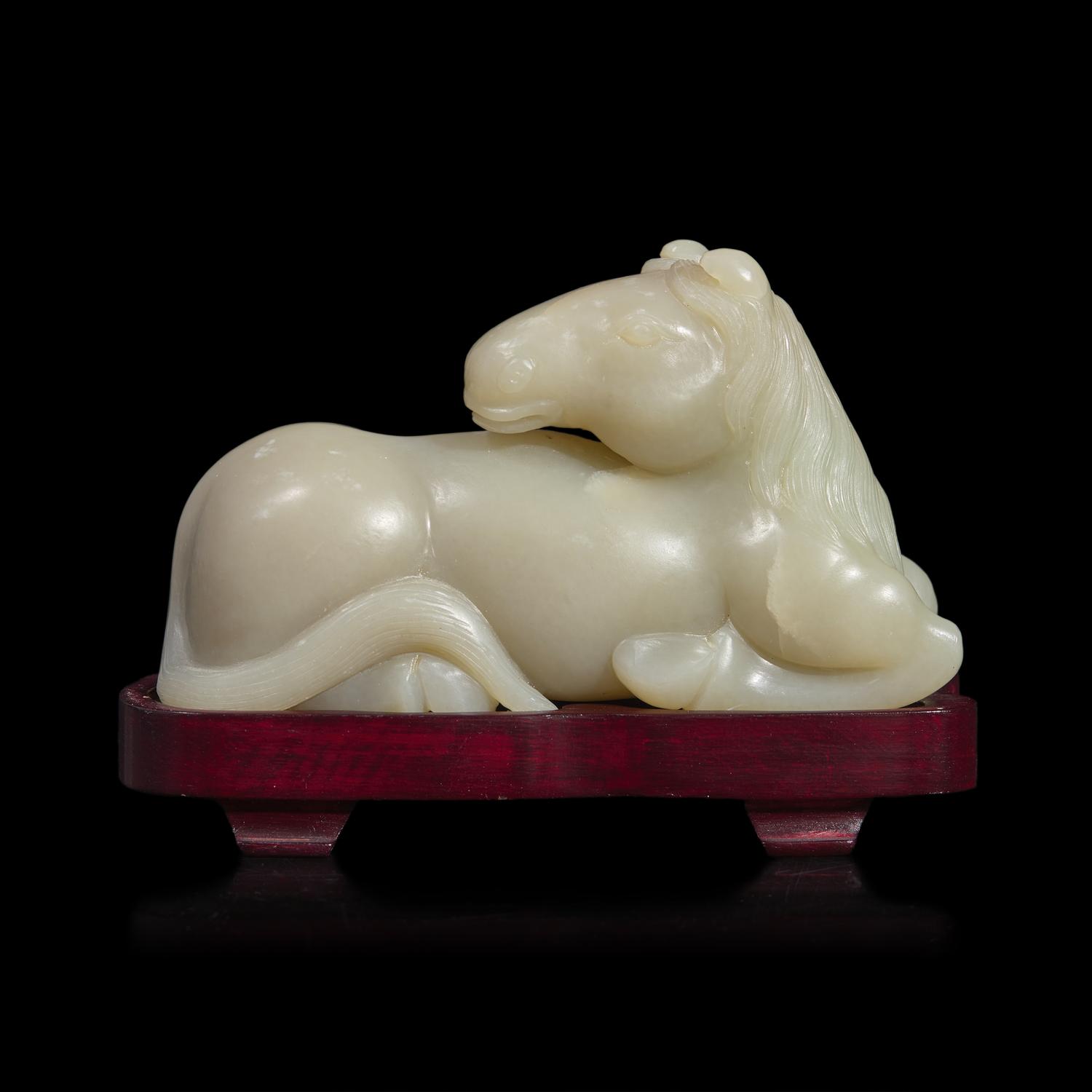 A Chinese Carved Pale Celadon Jade Horse, 20th Century 近代 青白玉臥馬