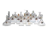 Fifteen Glass Decanters with English Shell-Form Silver Bottle Tags