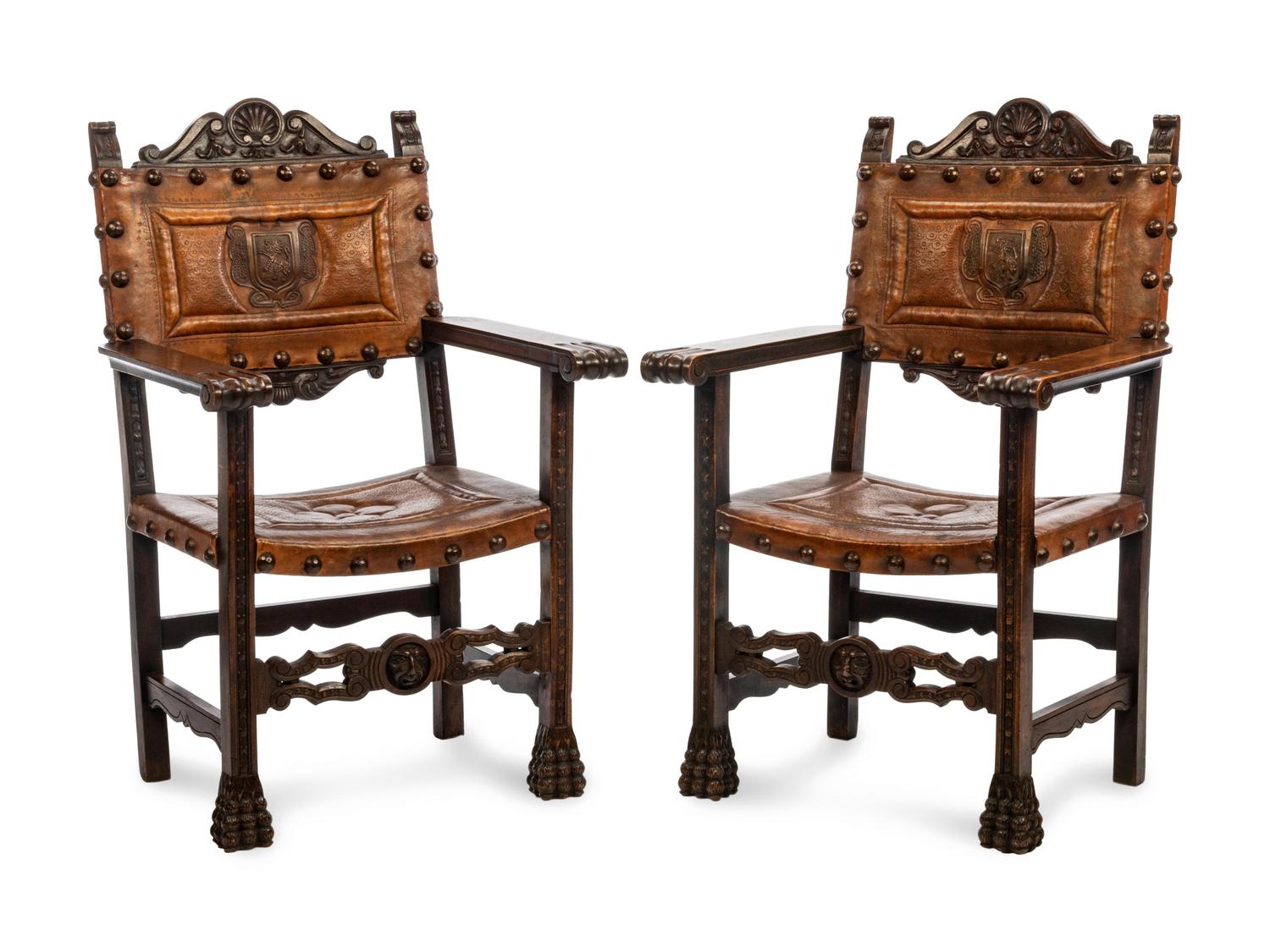 A Pair of Renaissance Revival Leather-Upholstered Oak Armchairs