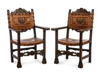 A Pair of Renaissance Revival Leather-Upholstered Oak Armchairs