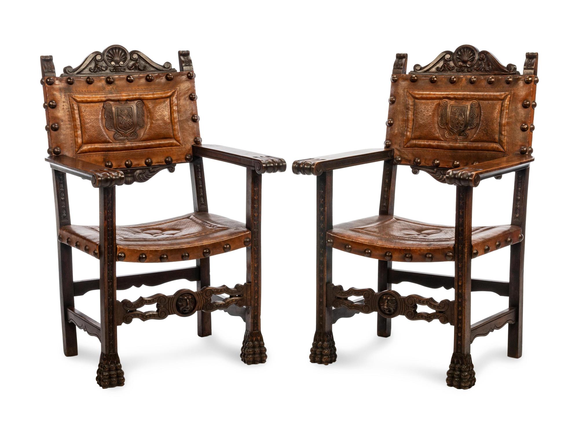 A Pair of Renaissance Revival Leather-Upholstered Oak Armchairs