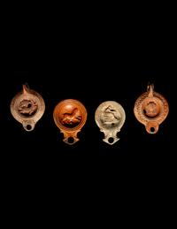 Four Roman Molded Terra Cotta Oil Lamps