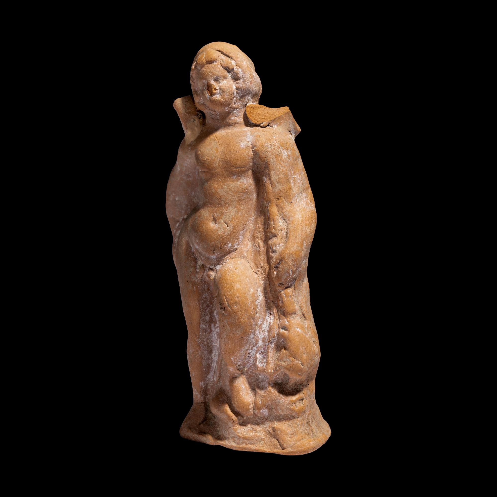 A Greek Terracotta Eros Holding a Club