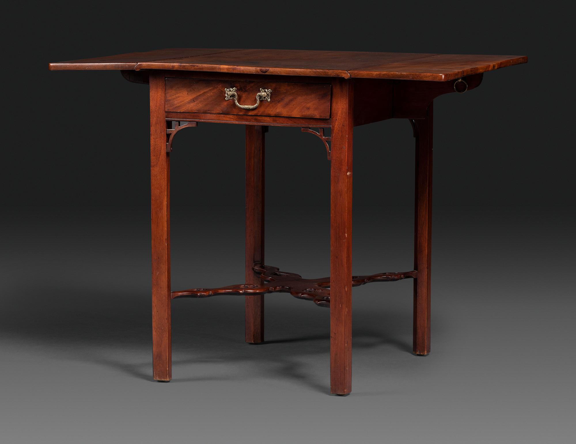 A Late Chippendale Carved and Figured Mahogany Stretcher-Base Pembroke Table