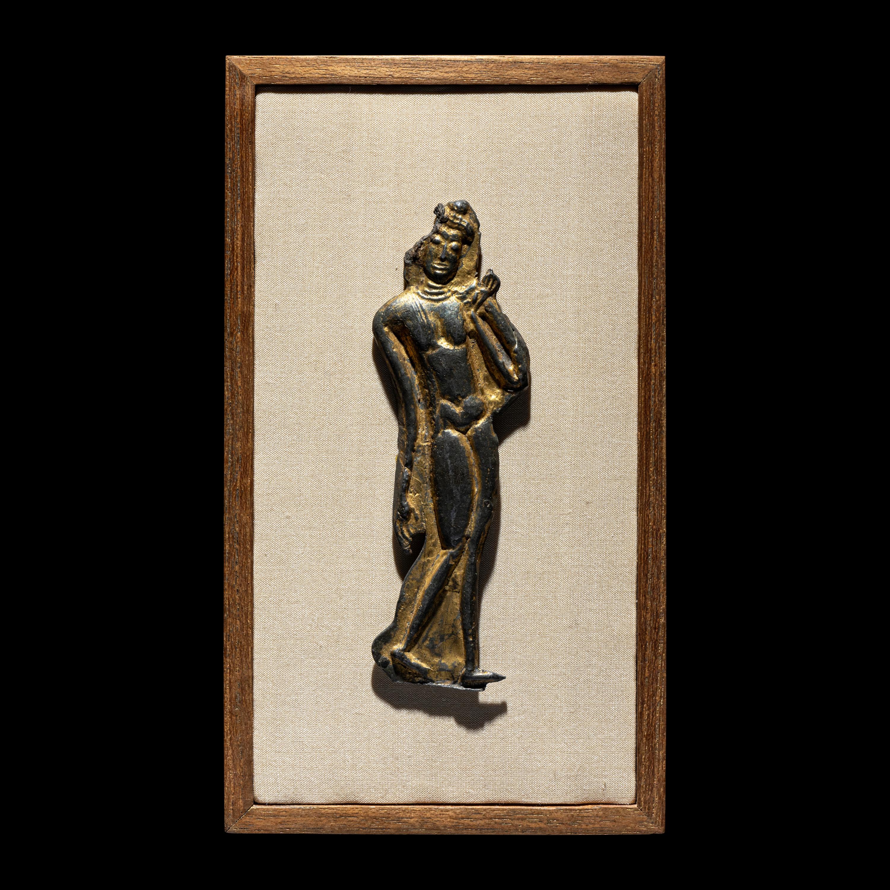A Thai Parcel Gilt Bronze Relief of a Walking Buddha, 16th-17th Century