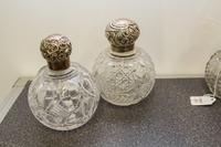 Two English Silver and Cut Glass Perfume Bottles, Charles May, Birmingham, 1916 and other, each having a spherical glass body with geom