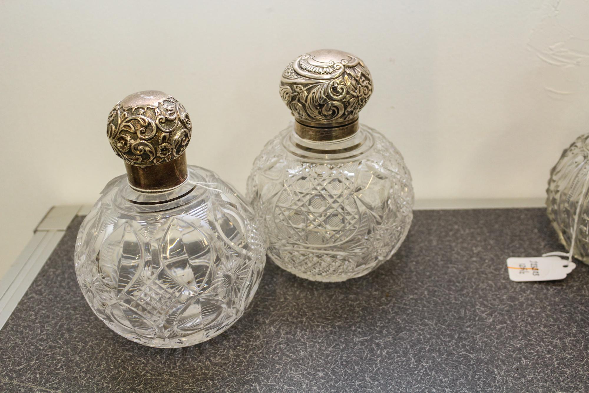 Two English Silver and Cut Glass Perfume Bottles, Charles May, Birmingham, 1916 and other, each having a spherical glass body with geom