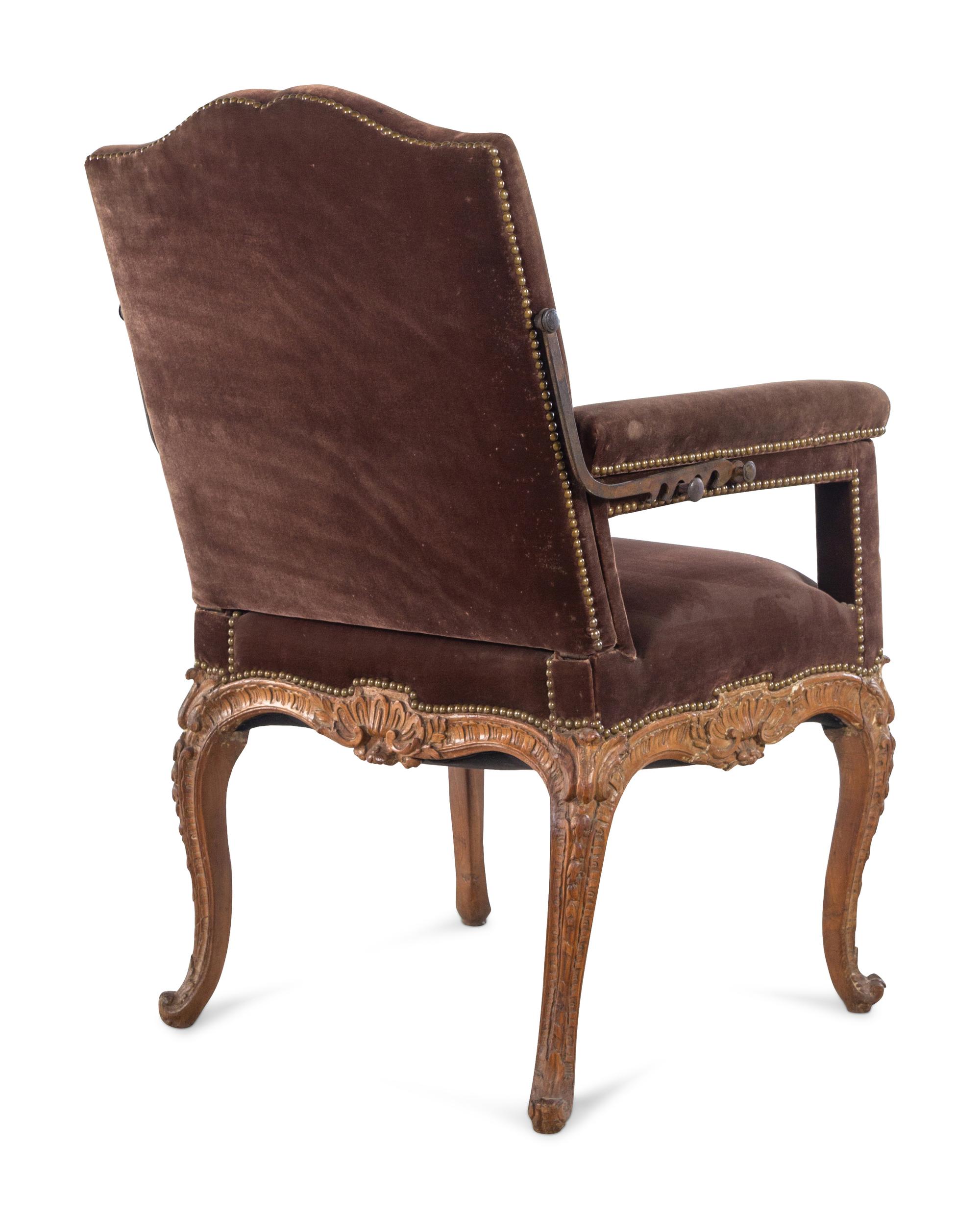 A Régence Velvet-Upholstered Carved Beechwood Reclining Armchair