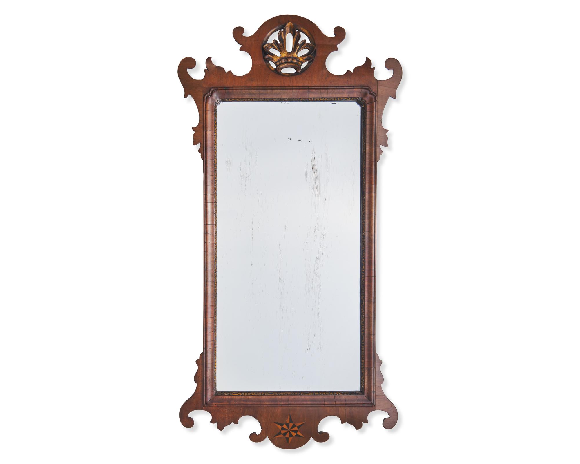 A Chippendale Fret-Carved and Parcel-Gilt and Inlaid Mahogany Mirror