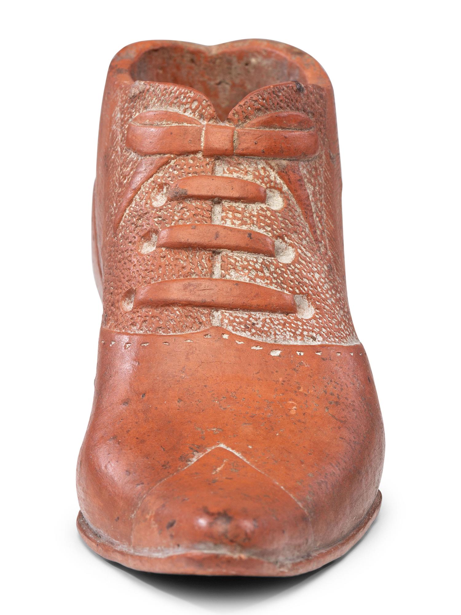 A Glazed Pottery Woman's High-Heeled Shoe