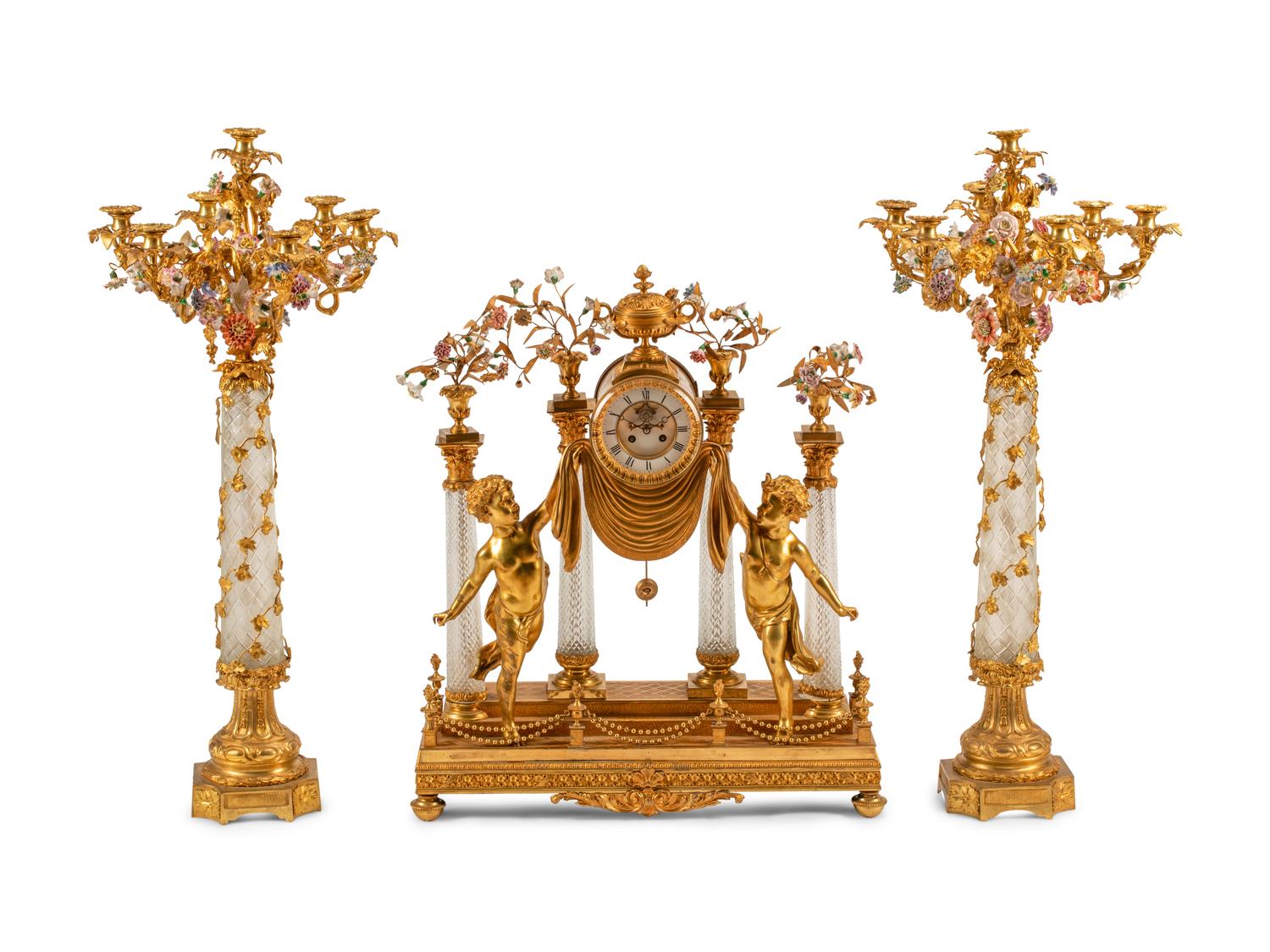 A Louis XV Style Gilt Bronze, Porcelain and Cut Glass Clock Garniture