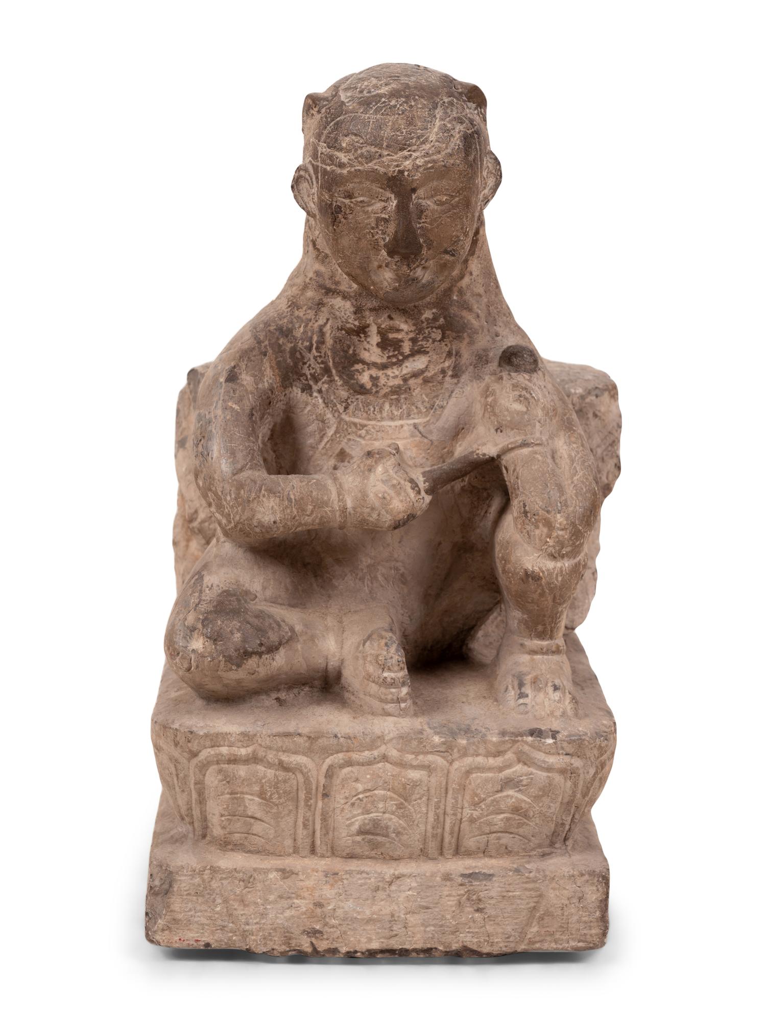 An Asian Carved Stone Seated Figure