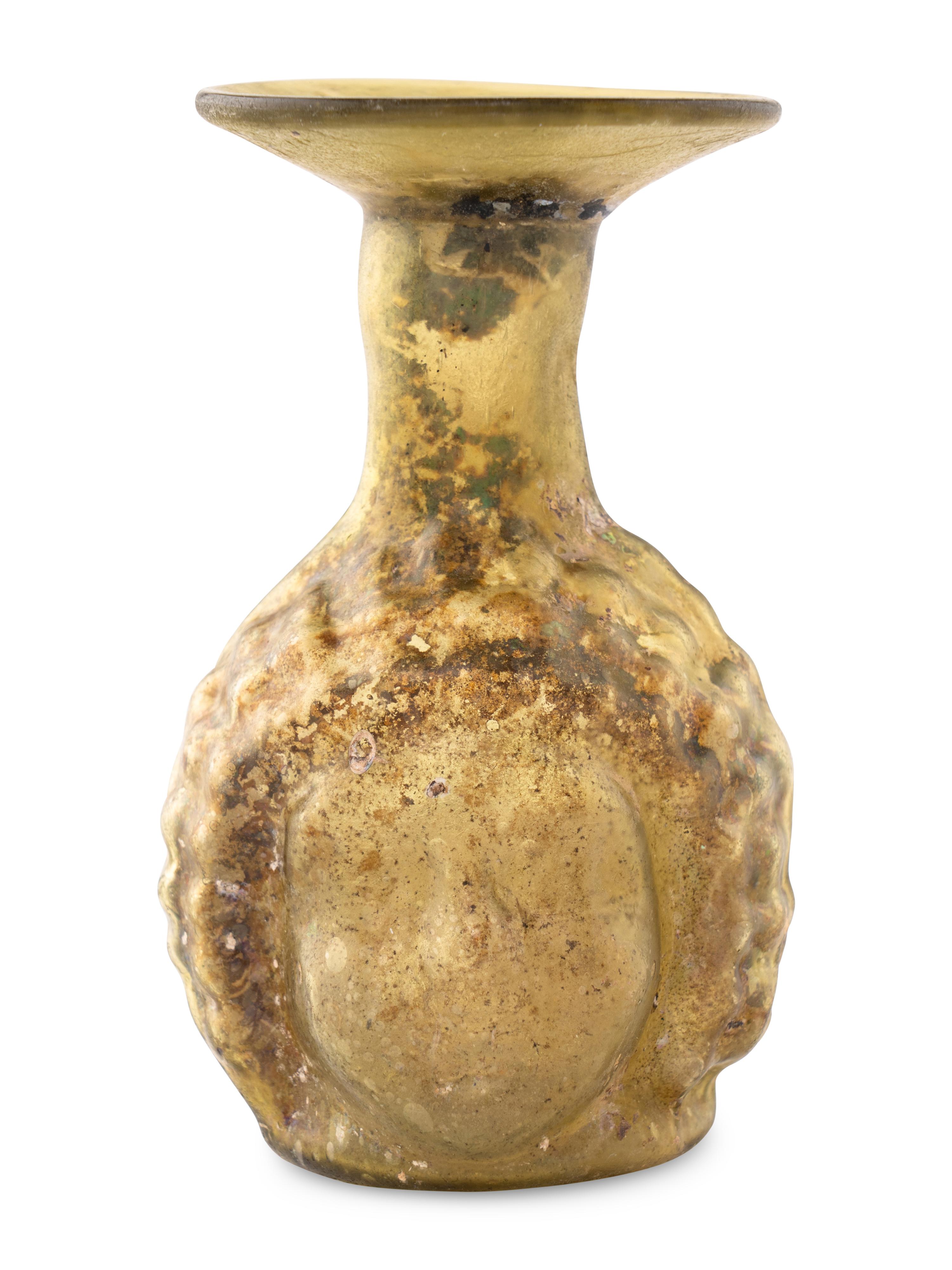A Roman Glass Janus Head Flask